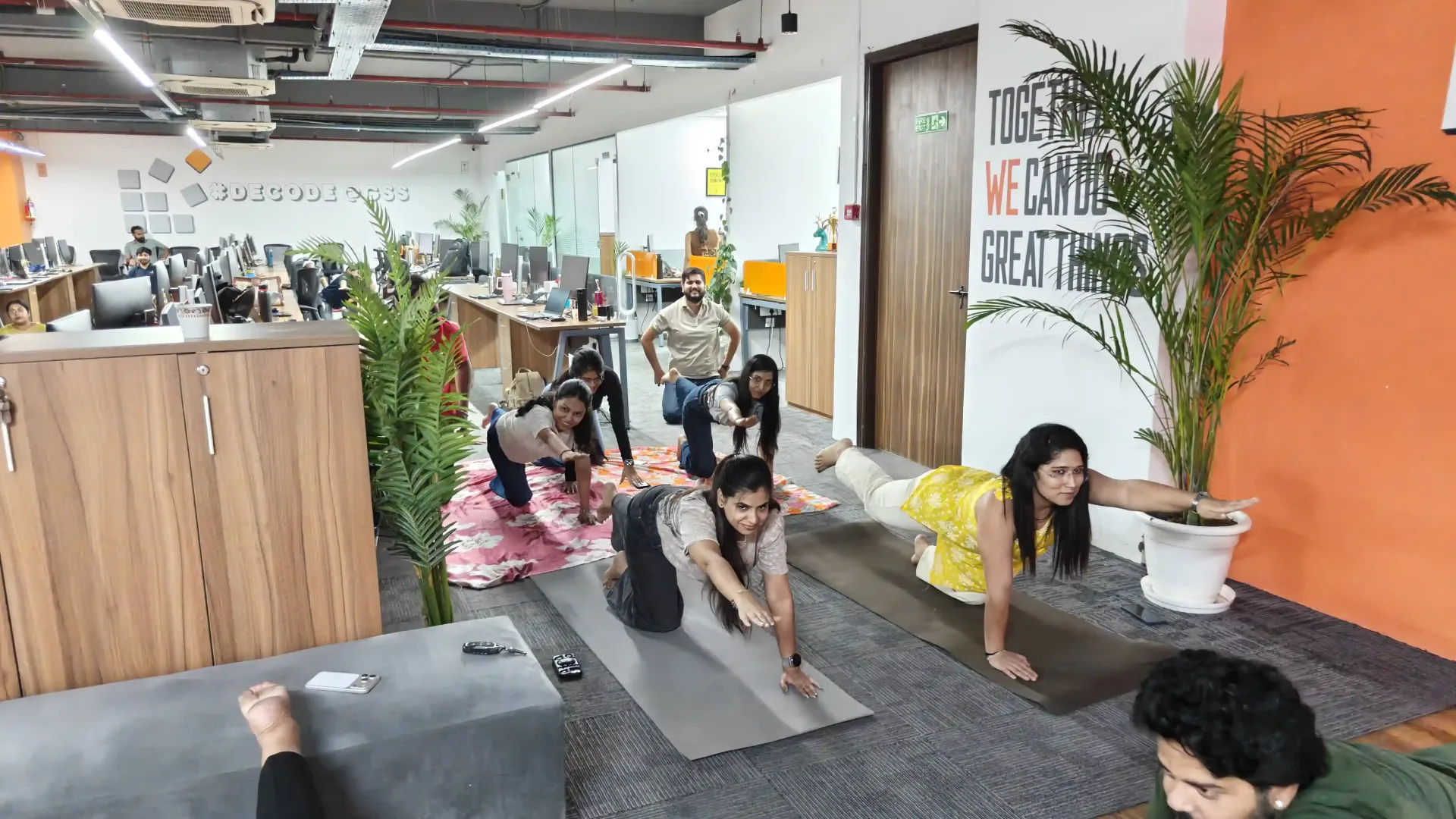 Office yoga session with stretching poses for International Yoga Day